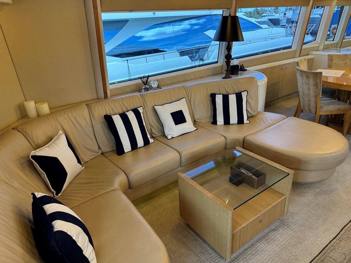 a living room with a large screen aboard DARE TO DREAM Yacht for Sale