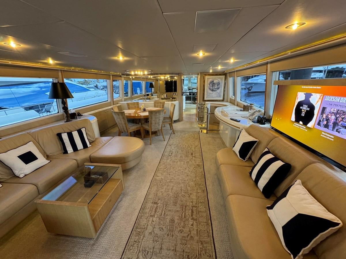 a living room with a large screen aboard DARE TO DREAM Yacht for Sale