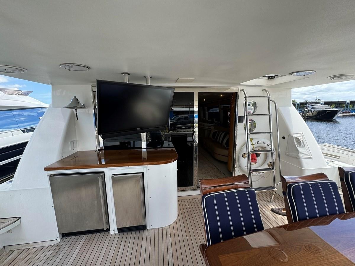 a boat with a tv on the deck aboard DARE TO DREAM Yacht for Sale