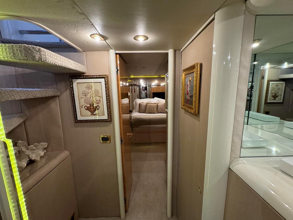 a hallway with a couch and a mirror aboard DARE TO DREAM Yacht for Sale