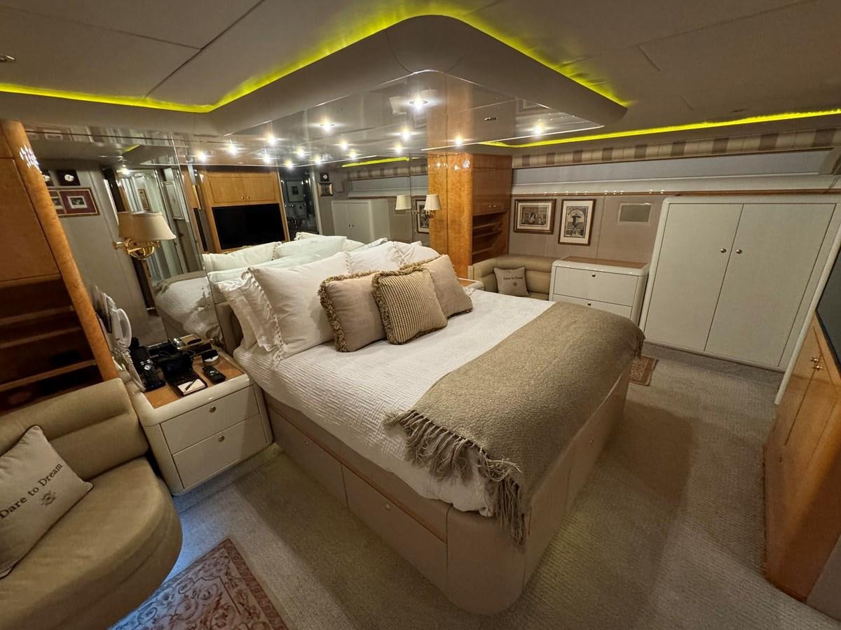 a room with a bed and a couch aboard DARE TO DREAM Yacht for Sale
