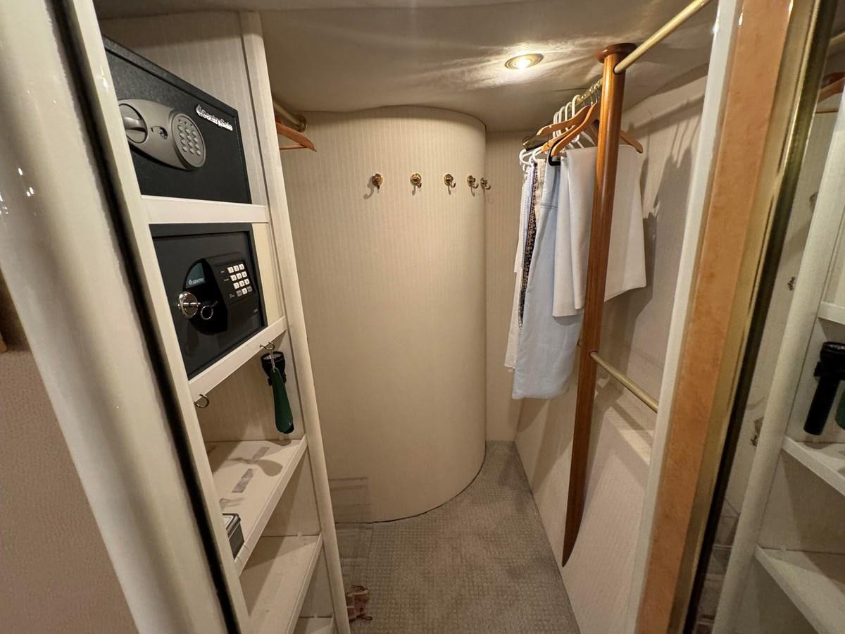 a closet with clothes on the wall aboard DARE TO DREAM Yacht for Sale