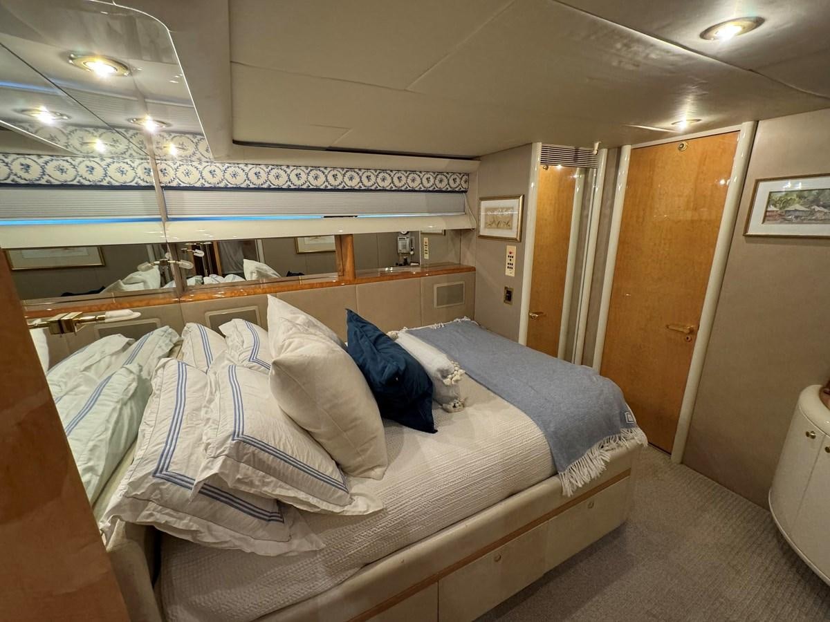 a room with a bed and a door aboard DARE TO DREAM Yacht for Sale