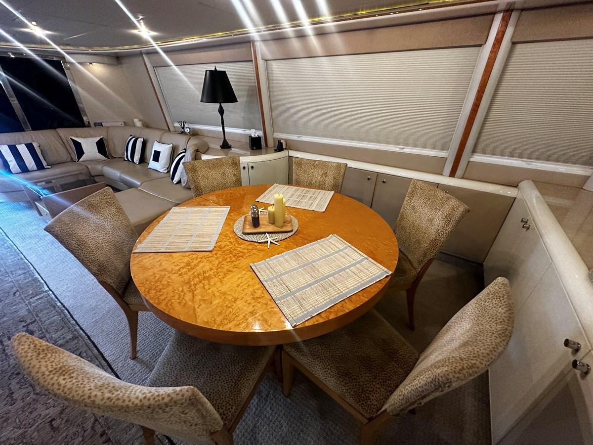 a table with chairs around it aboard DARE TO DREAM Yacht for Sale