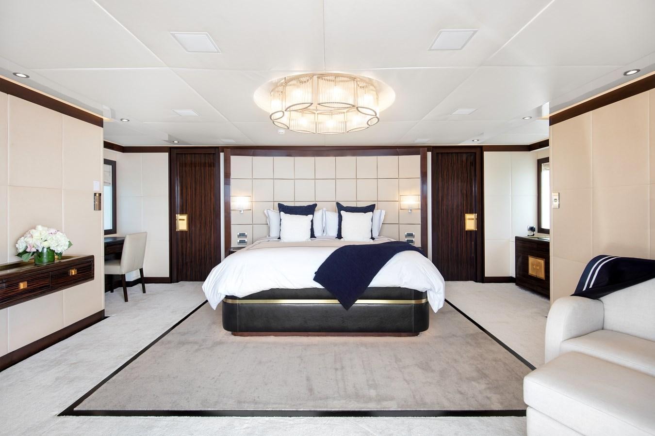 a large bedroom with a bed and a desk aboard MYSTIC Yacht for Sale