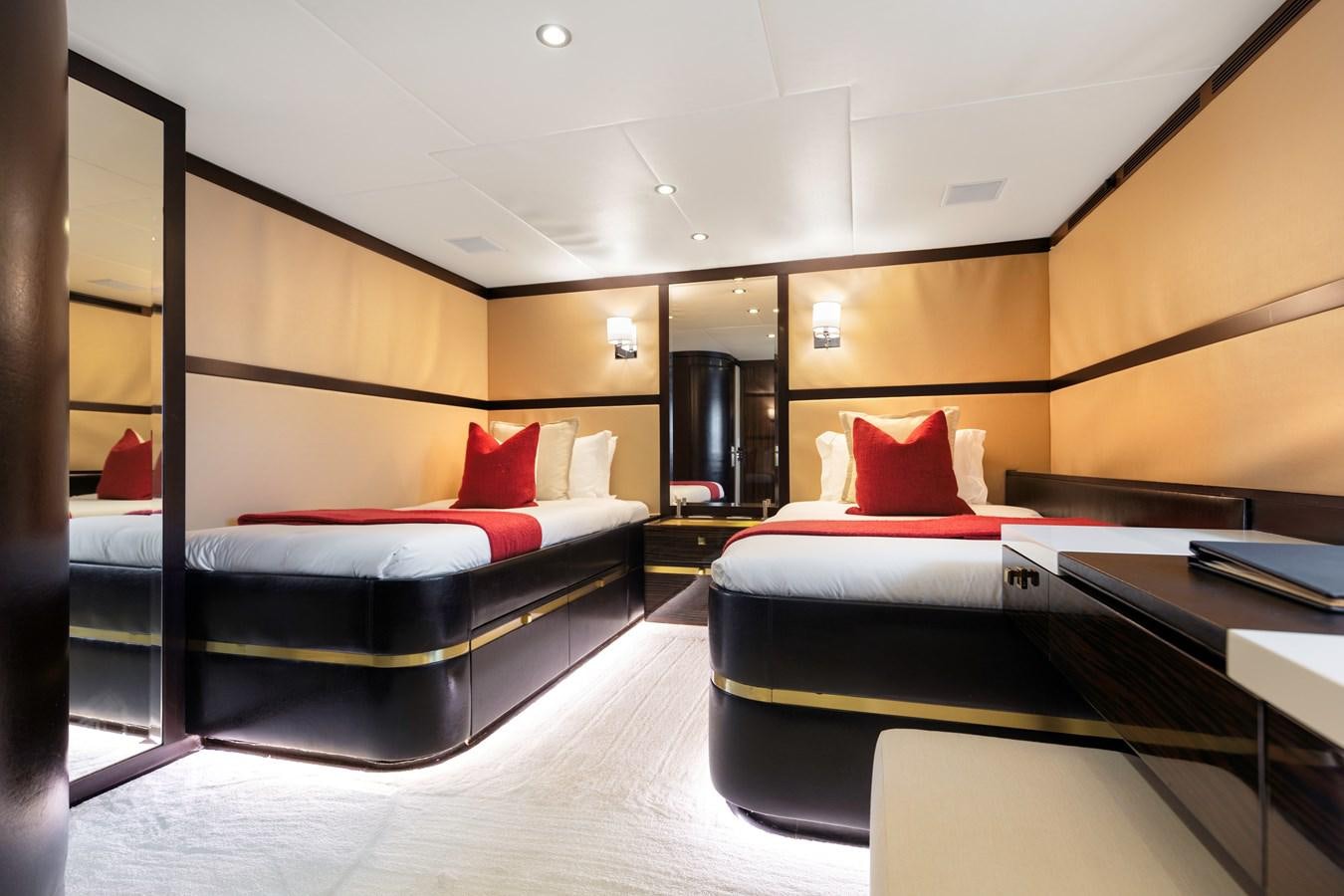 a room with a bed and a desk aboard MYSTIC Yacht for Sale