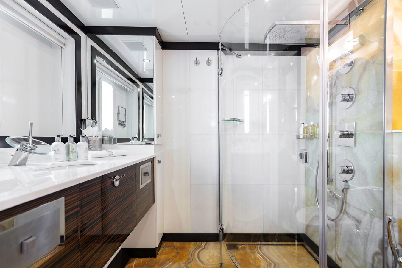 a bathroom with a glass shower aboard MYSTIC Yacht for Sale