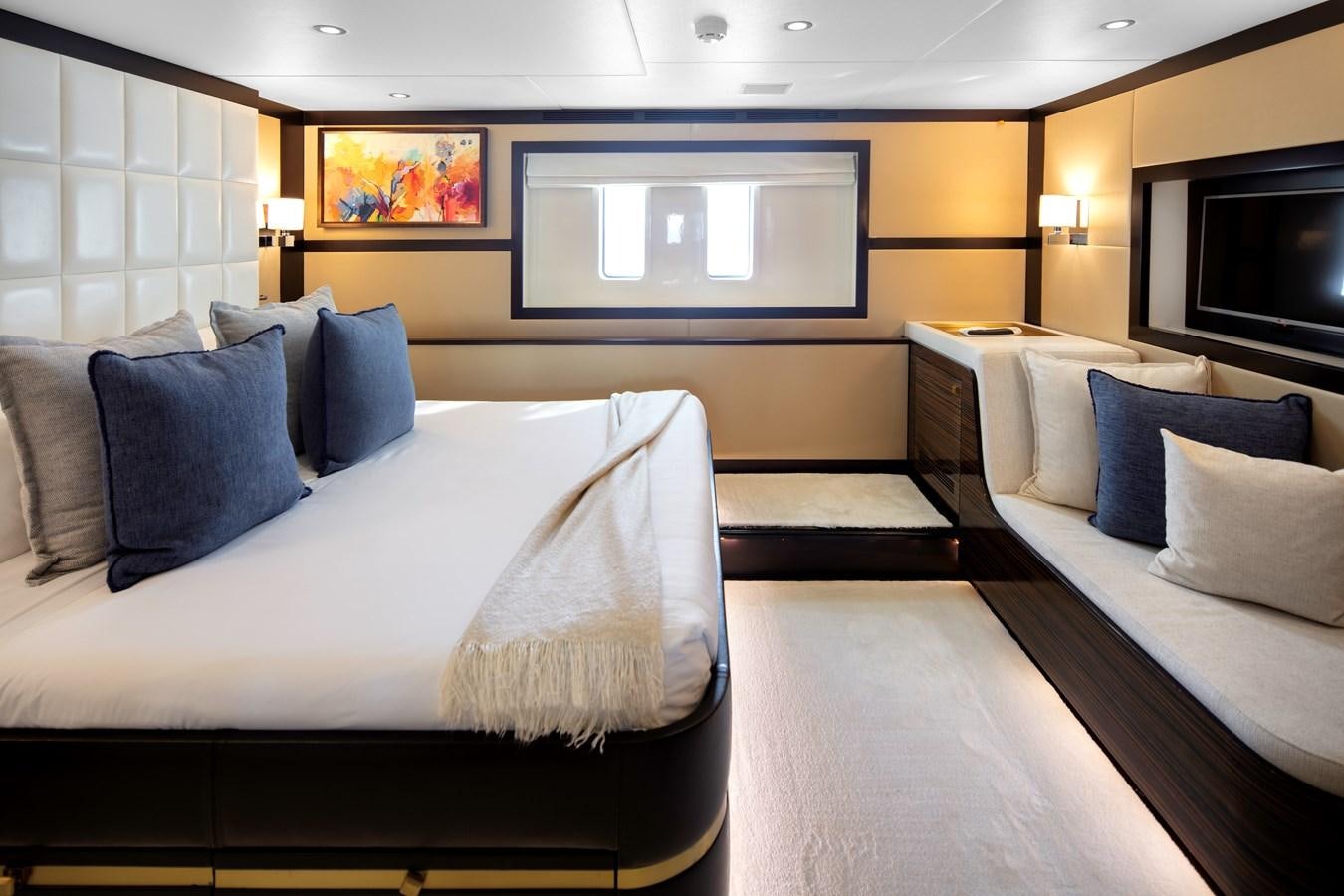 a living room with a couch and a tv aboard MYSTIC Yacht for Sale