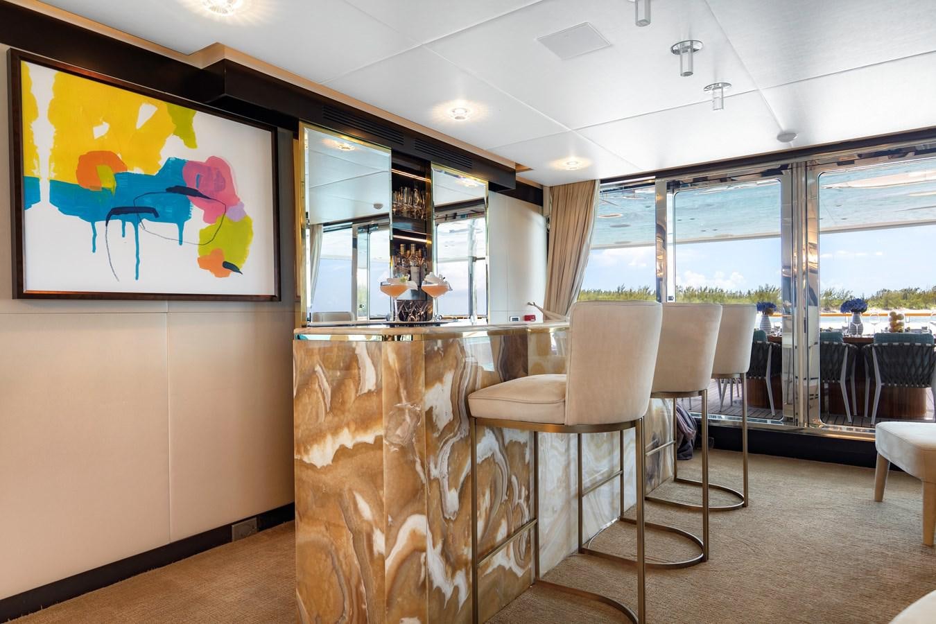 a room with chairs and a fireplace aboard MYSTIC Yacht for Sale