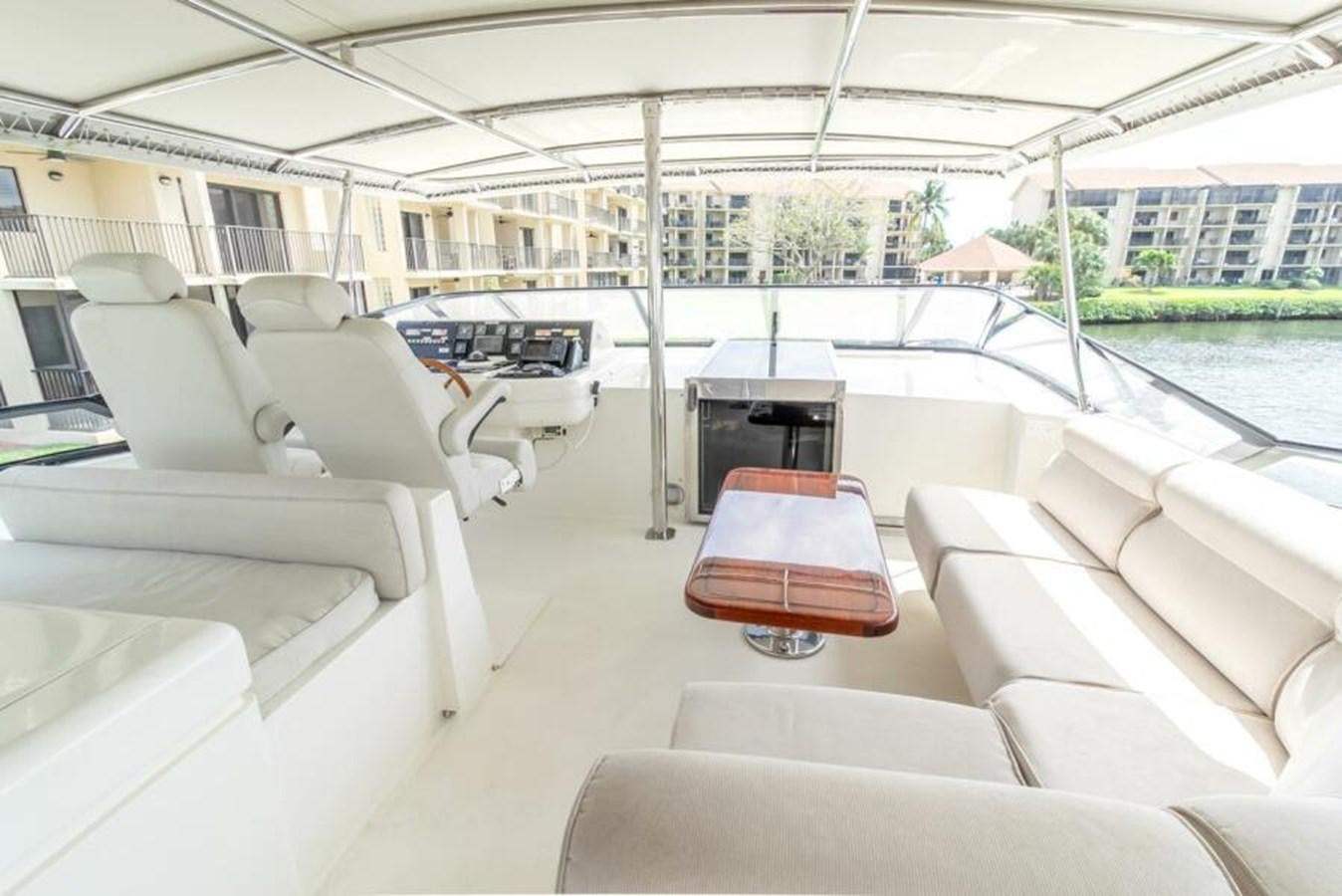 a boat with a deck and a table and chairs aboard SAND DOLLAR Yacht for Sale