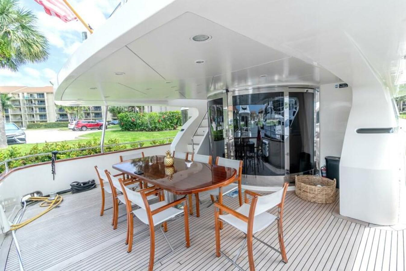 a table and chairs outside a house aboard SAND DOLLAR Yacht for Sale