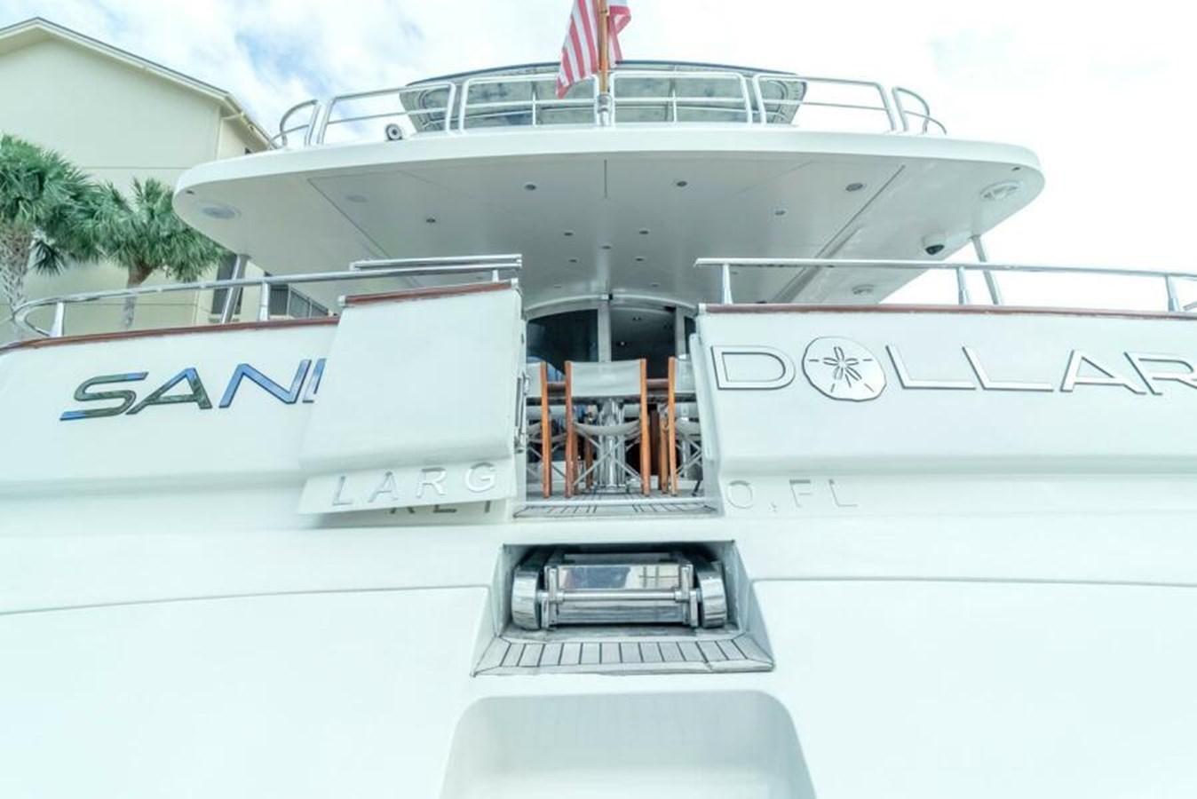 a white boat with a red stripe aboard SAND DOLLAR Yacht for Sale