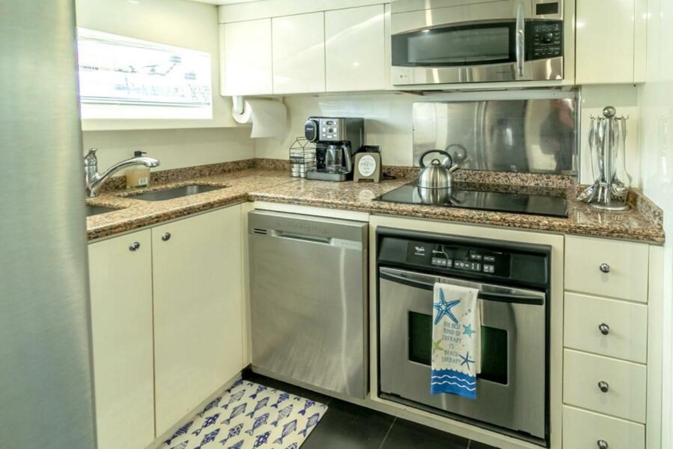 a kitchen with white cabinets aboard SAND DOLLAR Yacht for Sale