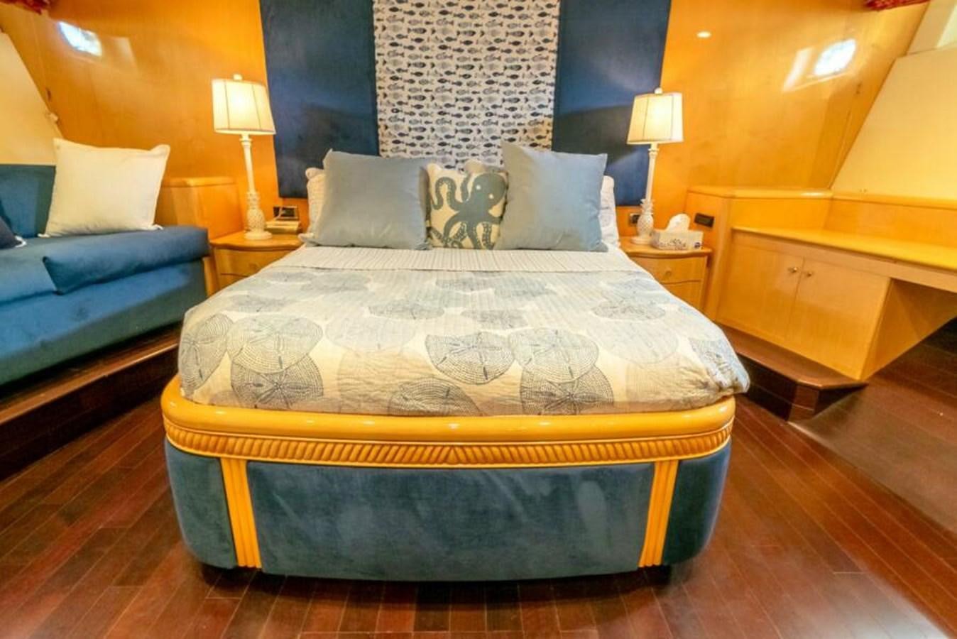 a bed with a blue comforter aboard SAND DOLLAR Yacht for Sale