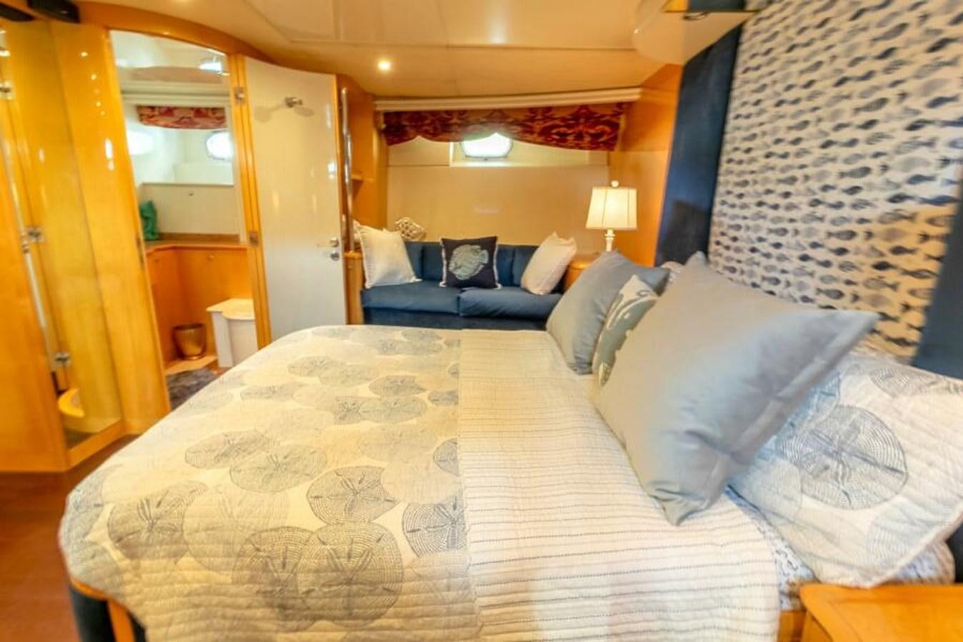 a bed with a white comforter aboard SAND DOLLAR Yacht for Sale