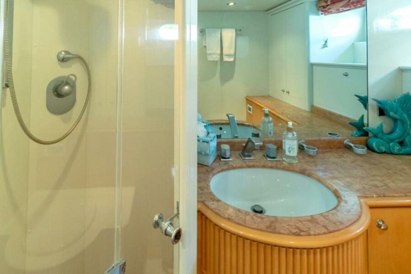 a bathroom with a sink and a shower aboard SAND DOLLAR Yacht for Sale