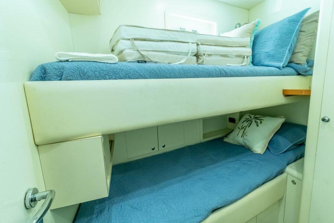 a bed with blue sheets aboard SAND DOLLAR Yacht for Sale