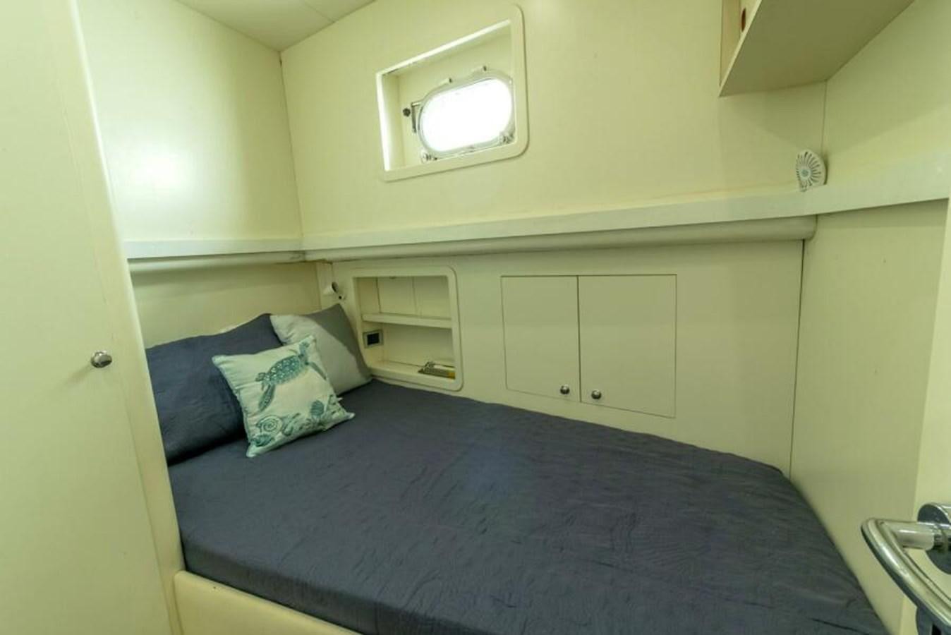 a bed with a blue comforter aboard SAND DOLLAR Yacht for Sale
