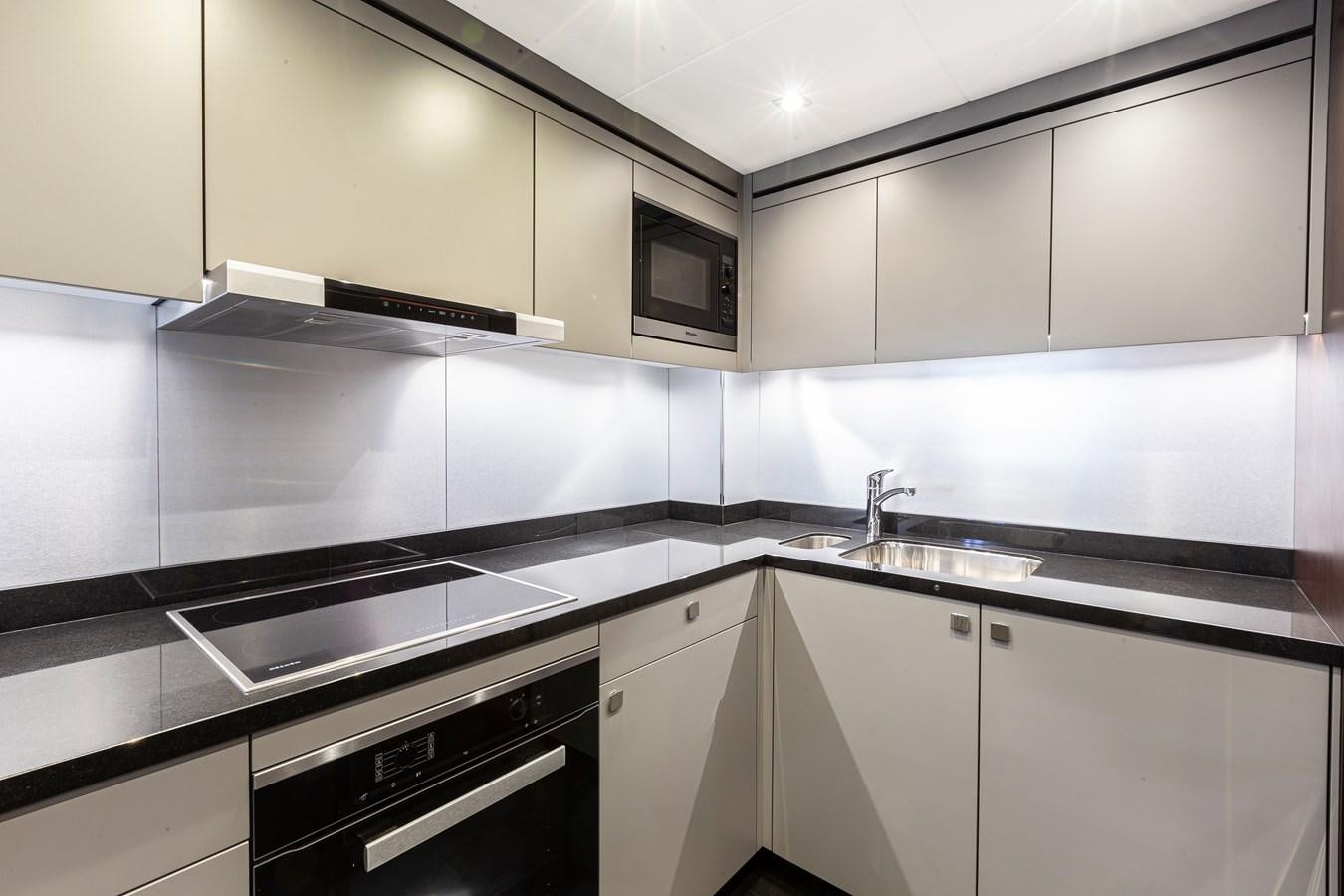 a kitchen with white cabinets aboard NEW EDGE Yacht for Sale