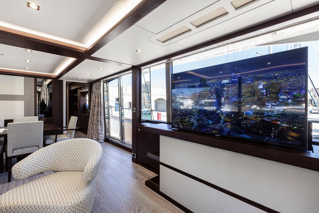a room with a large window and a view of a city aboard NEW EDGE Yacht for Sale
