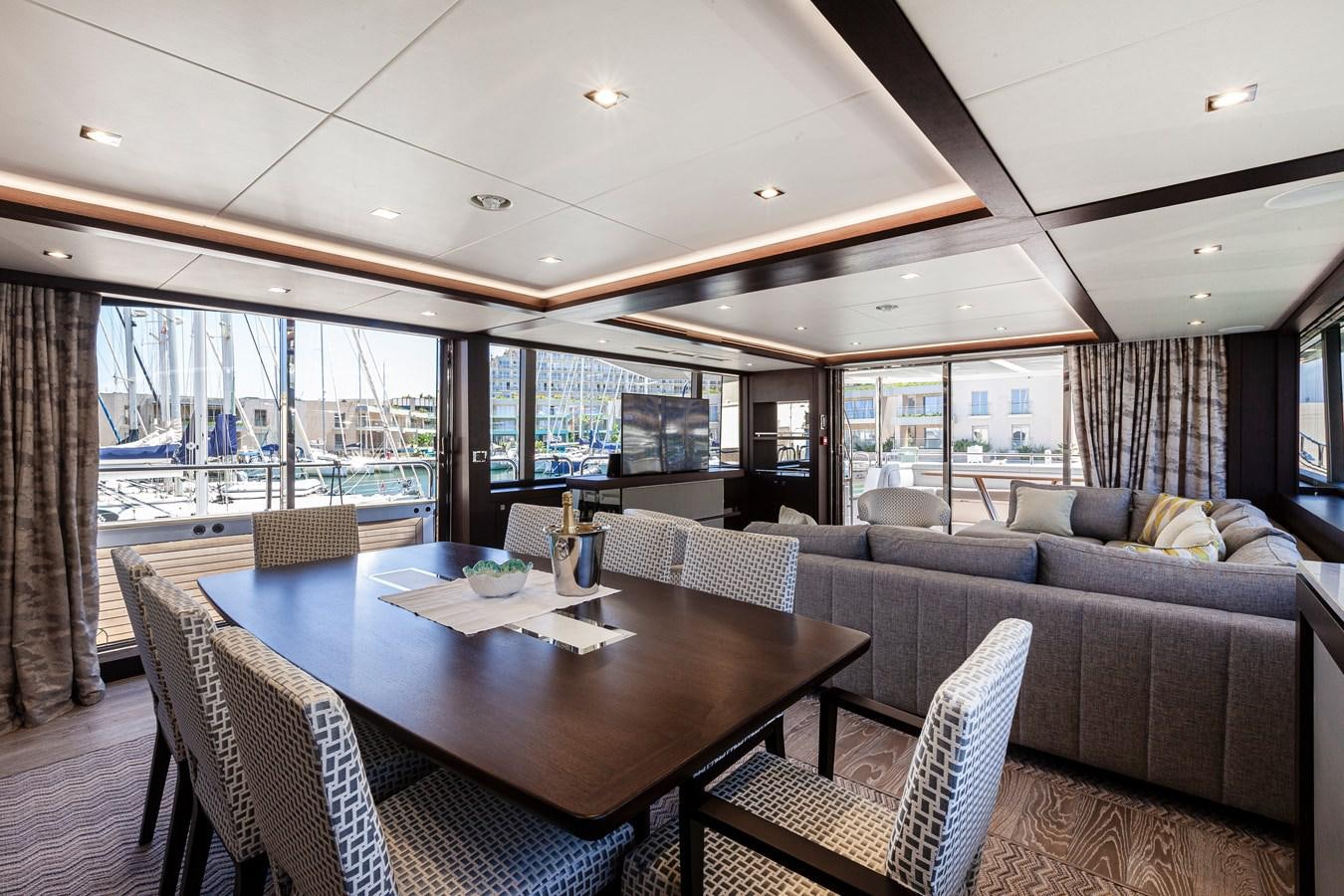 a living room with a large glass window aboard NEW EDGE Yacht for Sale