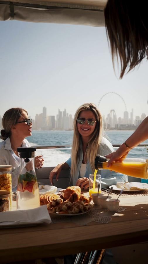 a group of women eating at a table aboard NEW EDGE Yacht for Sale