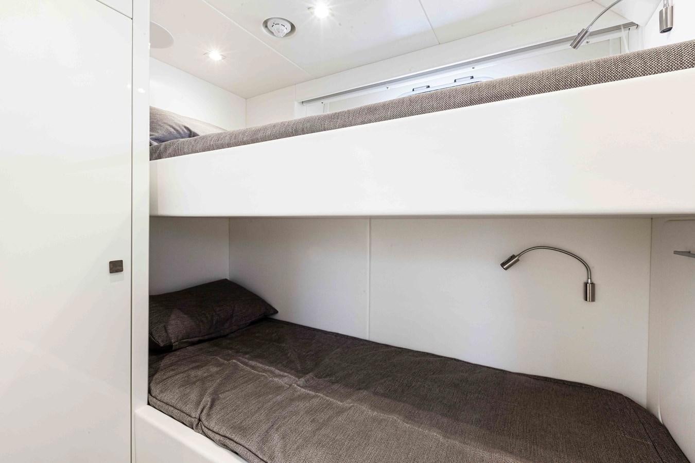 a bed with a lamp on the ceiling aboard NEW EDGE Yacht for Sale