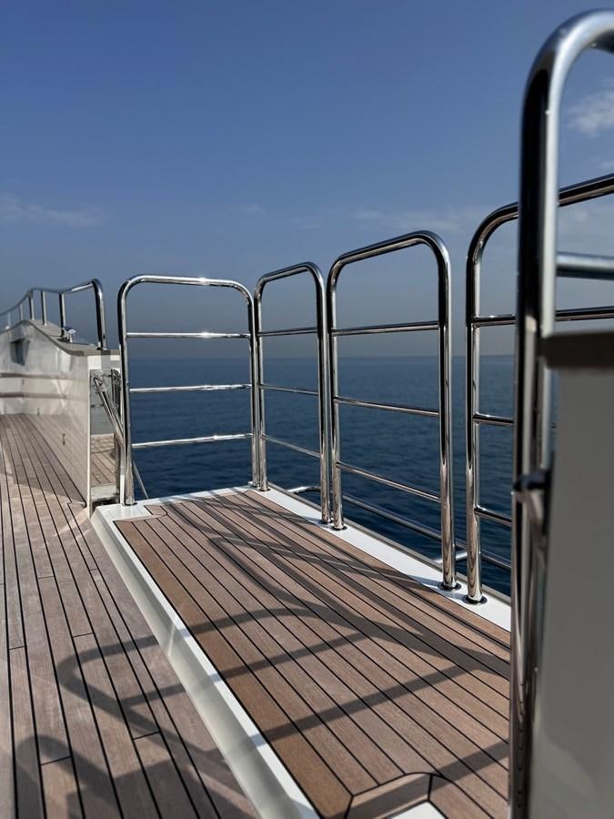 a long wooden walkway on a sunny day aboard NEW EDGE Yacht for Sale