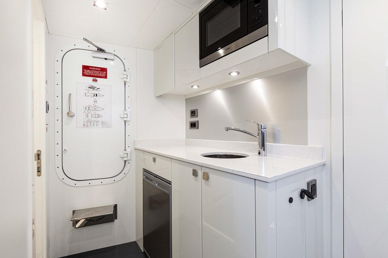a white refrigerator in a kitchen aboard NEW EDGE Yacht for Sale