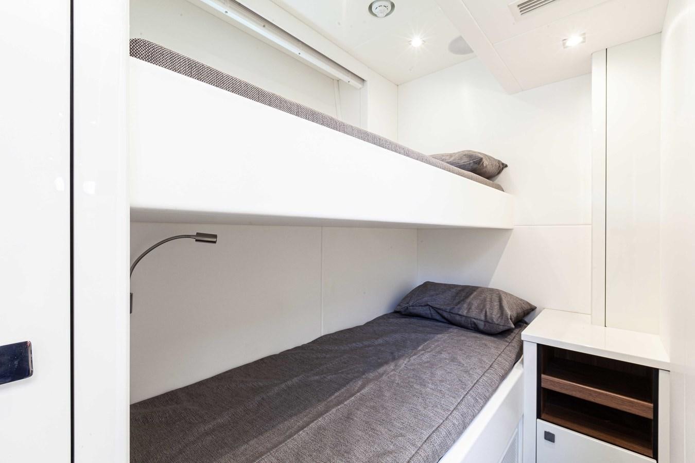 a bed with a black comforter aboard NEW EDGE Yacht for Sale
