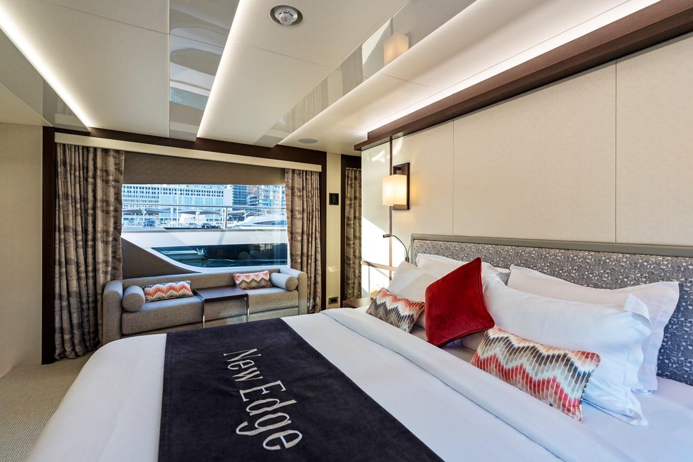 a bed with pillows and a window aboard NEW EDGE Yacht for Sale