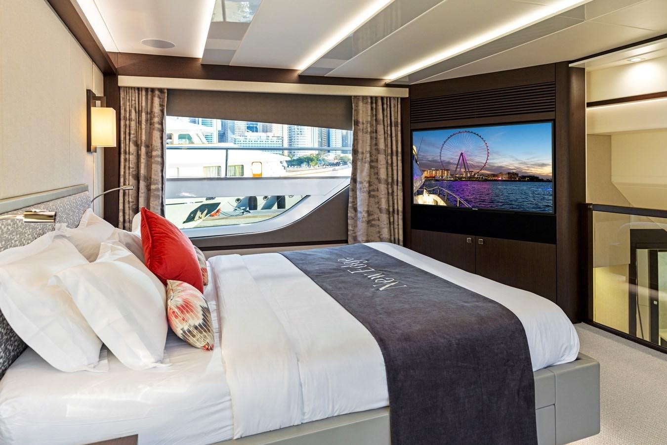 a bed with a large screen aboard NEW EDGE Yacht for Sale