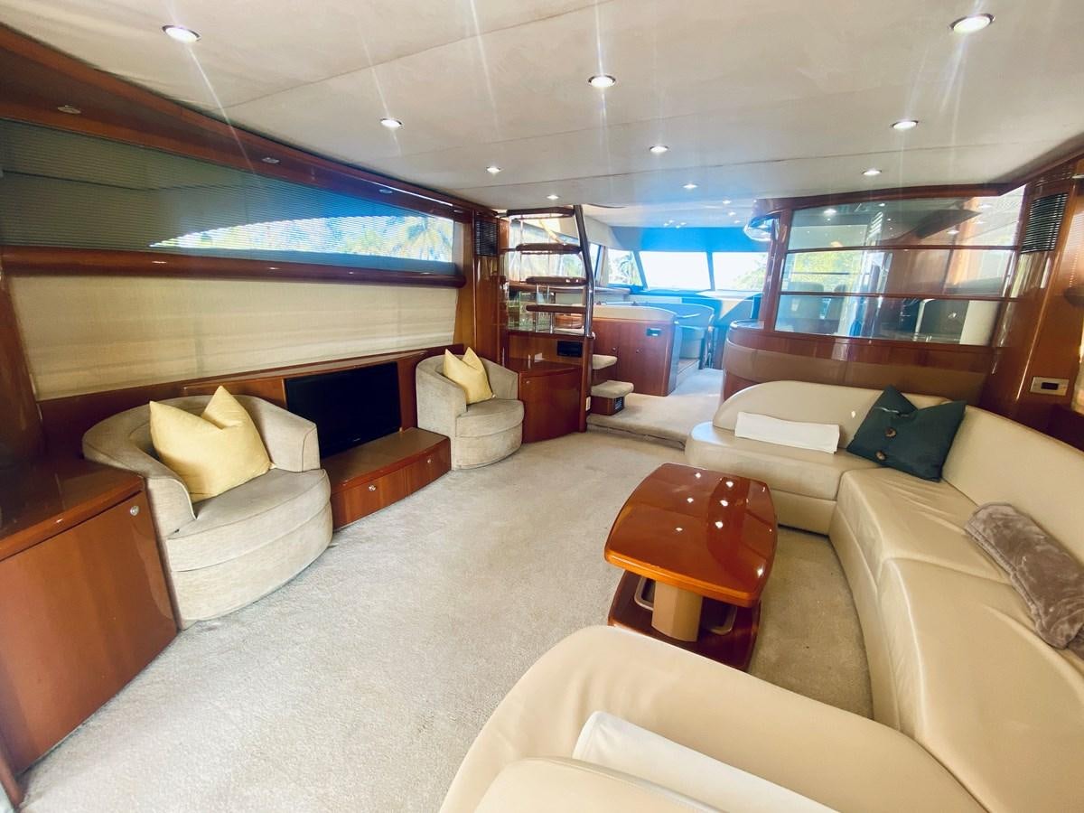 a room with a large bed and a bookcase aboard GRAND CRU Yacht for Sale