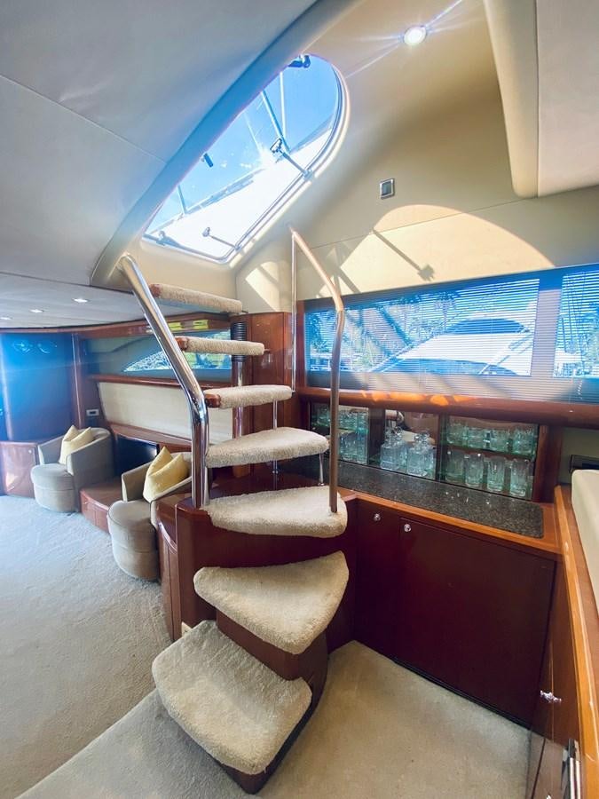 a room with chairs and a table aboard GRAND CRU Yacht for Sale