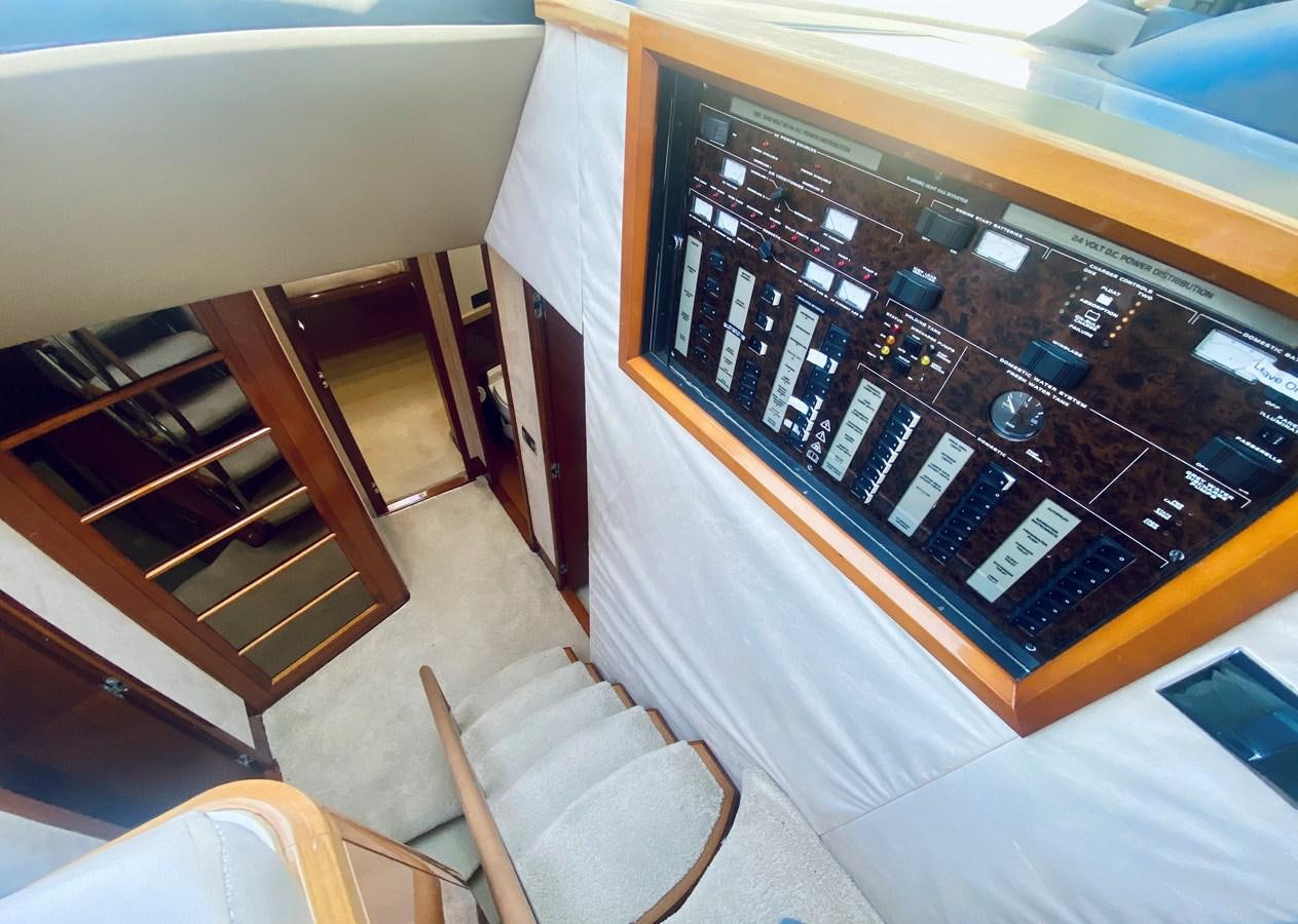 a room with a tv and chairs aboard GRAND CRU Yacht for Sale
