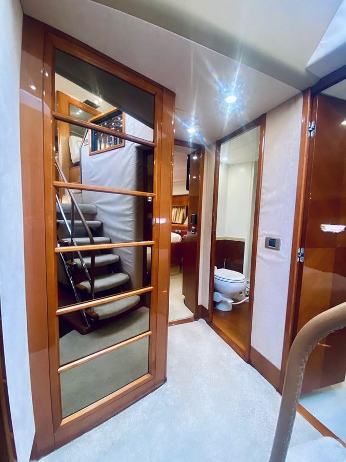 a room with a mirror and a shelf with books on it aboard GRAND CRU Yacht for Sale