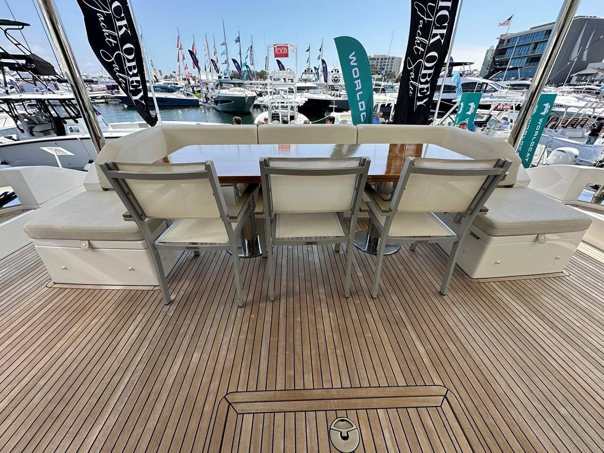 a table with chairs on it aboard SLINGSHOT Yacht for Sale