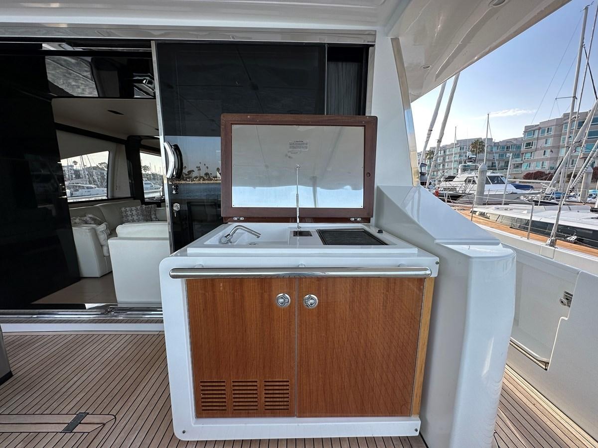 a room with a tv and a window aboard SLINGSHOT Yacht for Sale