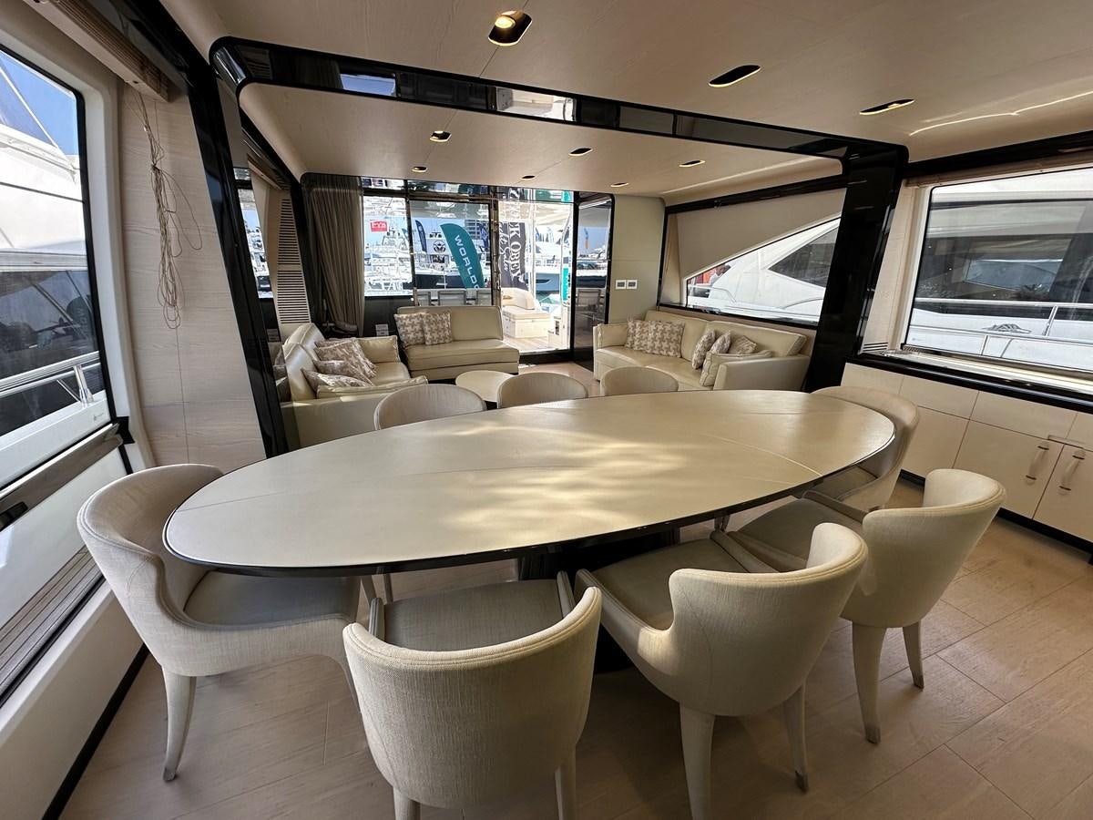 a table with chairs around it aboard SLINGSHOT Yacht for Sale