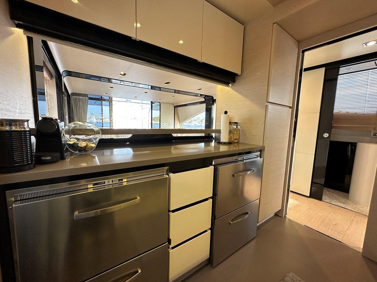 a kitchen with a glass window aboard SLINGSHOT Yacht for Sale