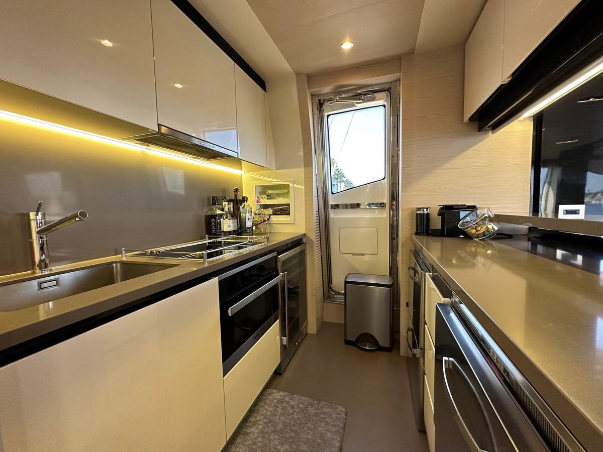 a kitchen with a sink and stove aboard SLINGSHOT Yacht for Sale
