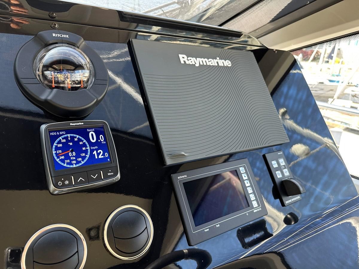 a car with a screen and other electronic devices in it aboard SLINGSHOT Yacht for Sale
