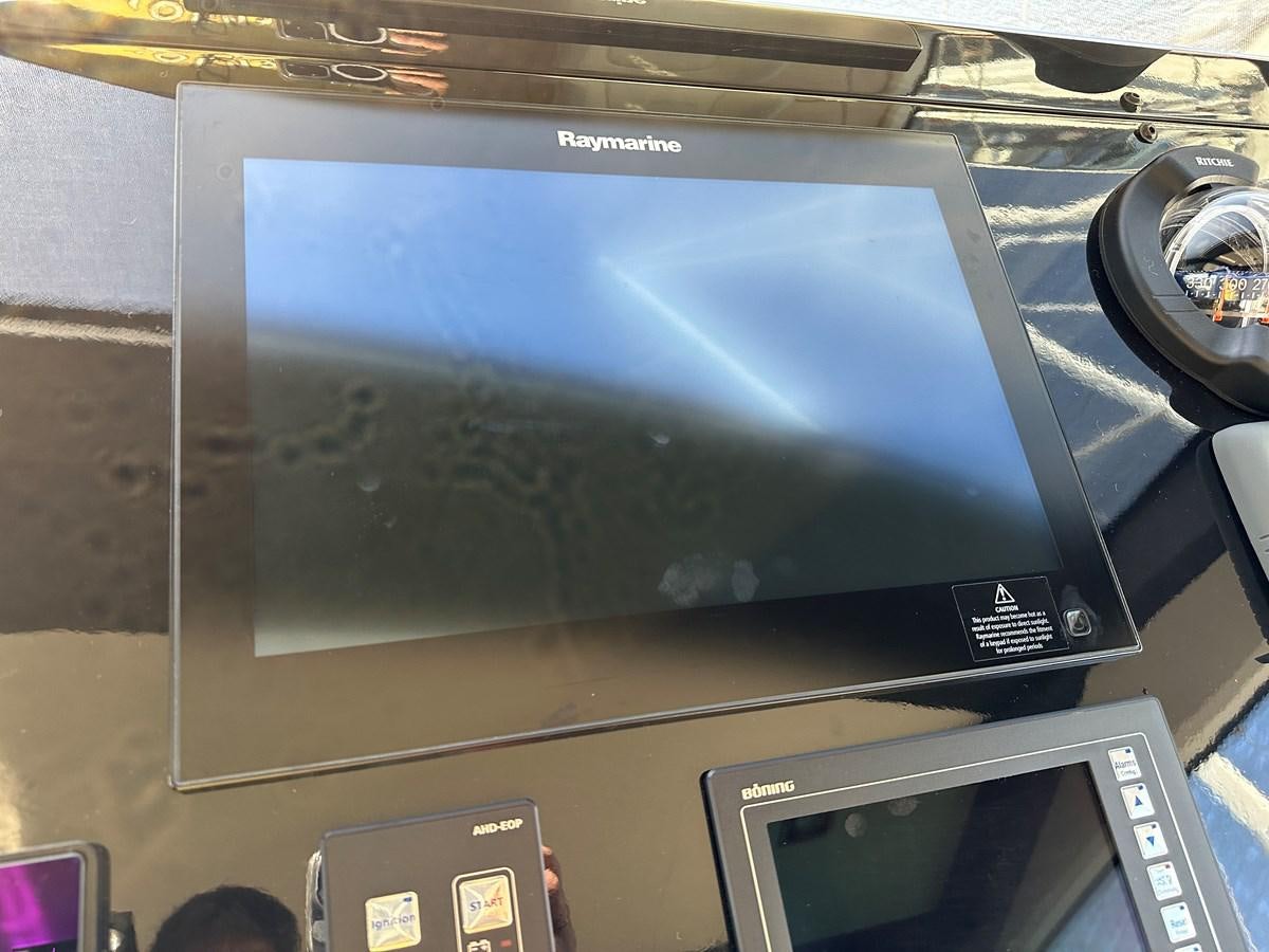 a tablet on a table aboard SLINGSHOT Yacht for Sale