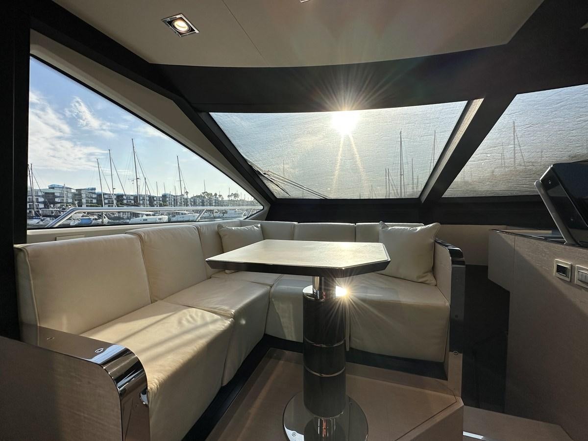 a room with a table and chairs aboard SLINGSHOT Yacht for Sale