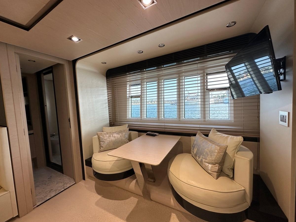 a room with a couple of couches and a table aboard SLINGSHOT Yacht for Sale