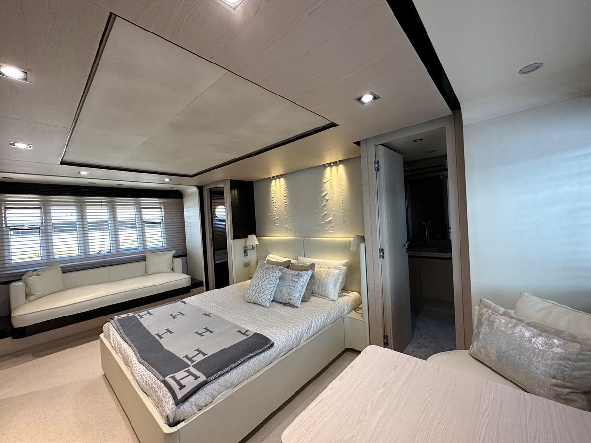 a bedroom with a bed and a couch aboard SLINGSHOT Yacht for Sale
