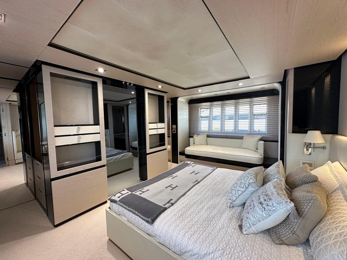 a bedroom with a bed and a tv aboard SLINGSHOT Yacht for Sale