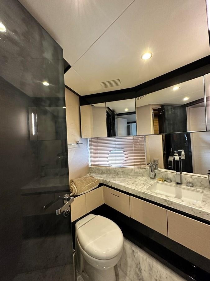 a bathroom with a toilet and a sink aboard SLINGSHOT Yacht for Sale