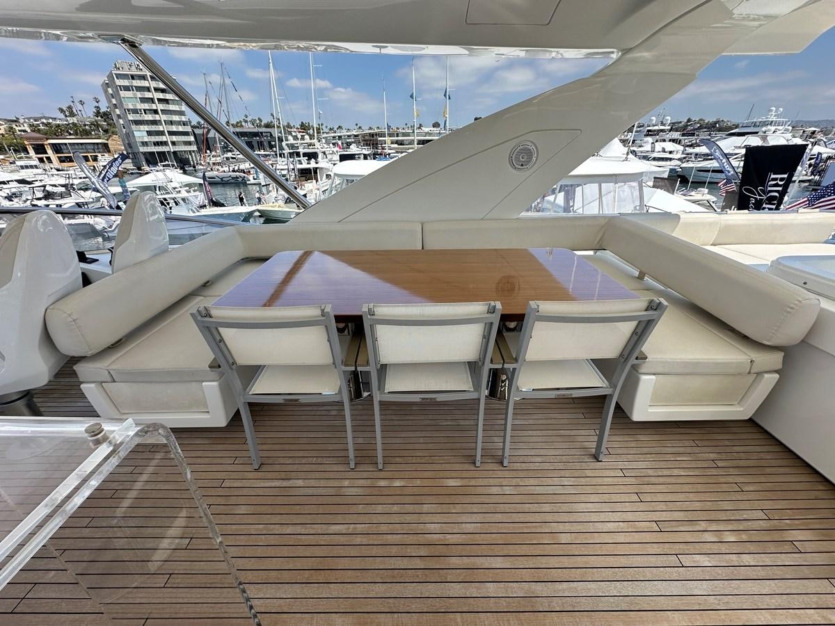 a deck with chairs and a table on it aboard SLINGSHOT Yacht for Sale