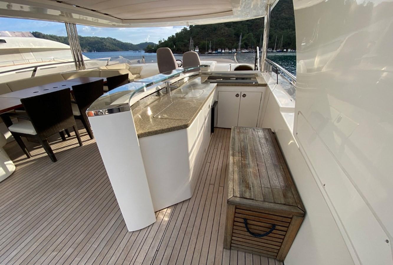 a deck with a table and chairs aboard SEZI MEGA Yacht for Sale